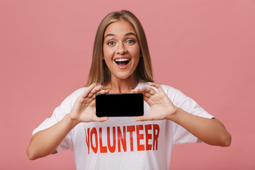 Happy young volunteer girl standing isolated
