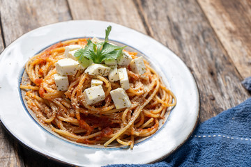 Spaghetti pasta with fresh and parmesan cheese on wooden background