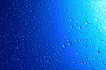 Fototapeta na wymiar Sparkling water droplets on translucent blue