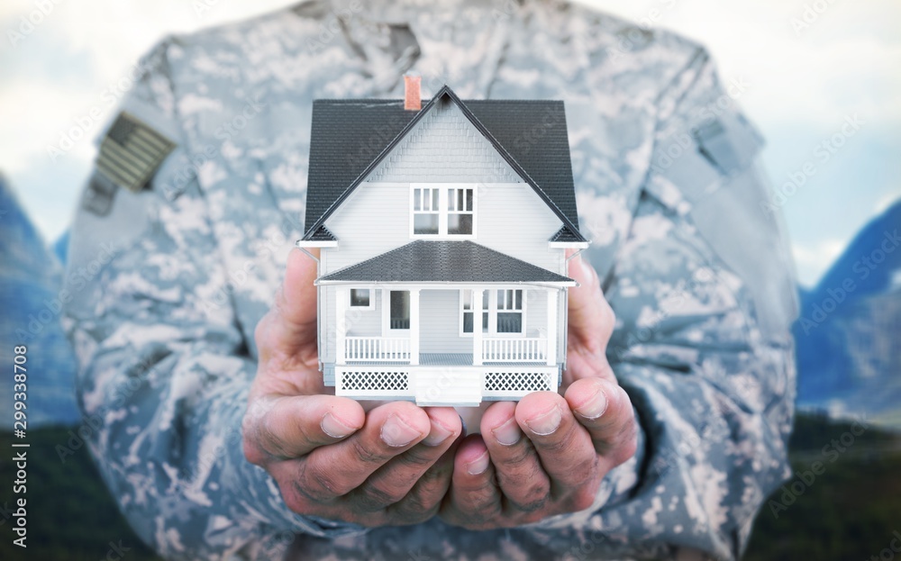 Sticker Miniature house in soldier hands, close up