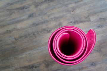 Pink yoga mat is located inside the room.