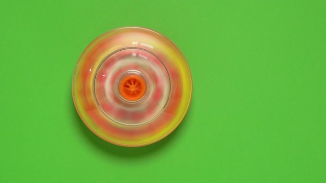 Kids whirligig top toy on green background