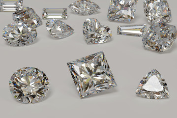 Variously cut diamonds scattered on white background with round, princess, trilliant cut stones on foreground.