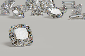 Variously cut diamonds scattered on white background with a cushion cut stone on foreground.