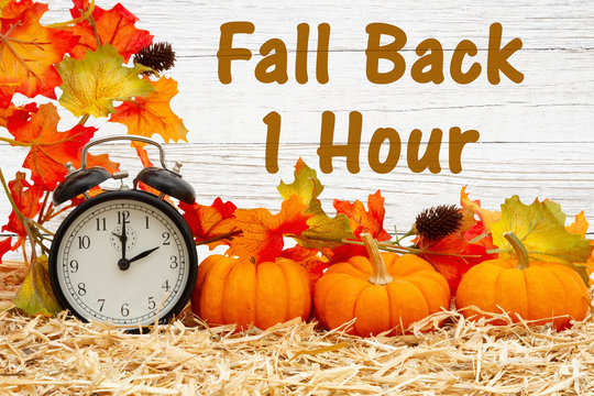 Fall Back 1 Hour Time Change Message With A Retro Alarm Clock With Pumpkins And Fall Leaves