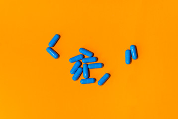 blue pills on orange abstract background