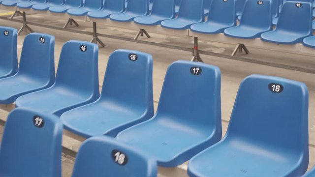 Empty blue plastic seats at stadium