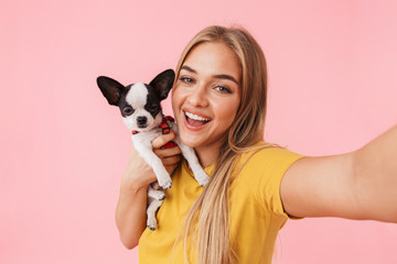 Cute lovely girl playing with her pet chihuahua