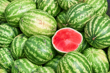 A total plan of a pile of watermelons on which lies the cut half of the watermelon. Half of the...