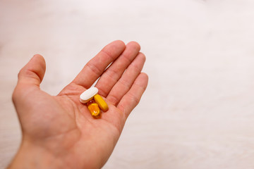 man hand holding Herbal supplement pill,eating healthy