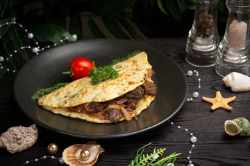 Chinese onion tortilla with beef and onions in a black plate