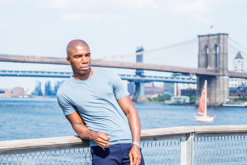 I missing you, waiting for you. Young African American Man traveling in New York City, wearing gray...