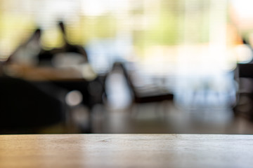Wooden table with blurred cafe background