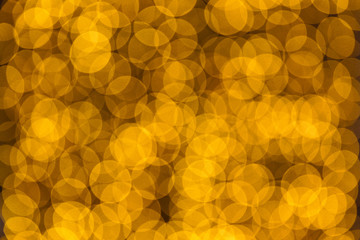 Christmas and New Year golden yellow background with abstract blurred highlights. Bokeh in blur.
