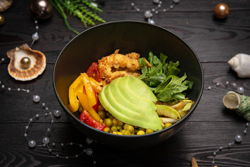 shrimp bowl with avocado in a black plate