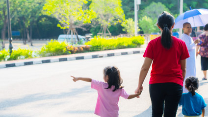 Asian family, mother, child, holding hands, traveling happily