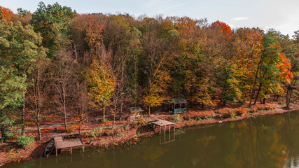 Fototapeta na wymiar Aerial top view. Autumn landscape. Lake in autumn forest