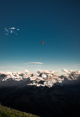 Helicopter Flying Over Mountains Against Sky During Sunset