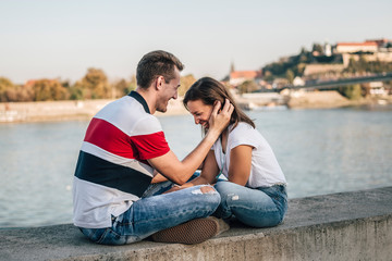 Young couple in love having fun together by the river.