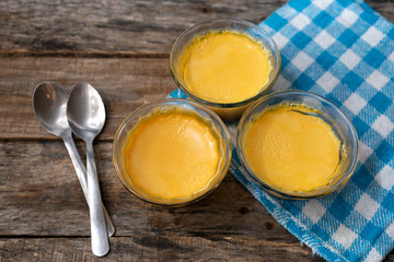 Vanilla flan dessert on wooden background