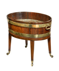 A Georgian mahogany wine cooler having brass banding and drop handles to the sides, raised on casters