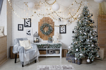 Modern black and white interior design room with Christmas and New Year decorations, toys, gifts, snow-covered fir tree, garlands. Winter holidays composition.