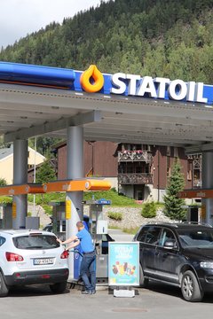 BAGN, NORWAY - AUGUST 2, 2015: People fill their cars at Statoil station in Bagn (Sor-Aurdal), Norway. Statoil is a multinational oil and gas company from Norway.