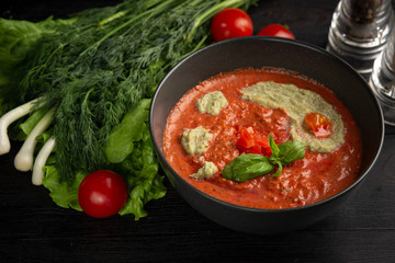 tomato cream soup in a black plate