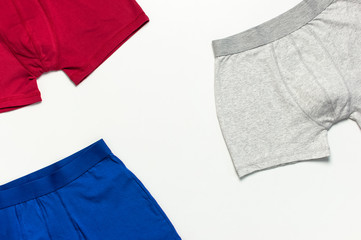 Men's underwear, set of multi-colored underpants on white background flat lay top view copy space....