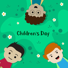 World Children's Day, three children who are lying on the grass are happily laughing