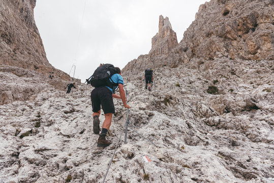 hiker on steep path in the dolomites