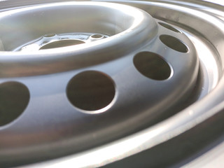 black metal car wheel with round holes