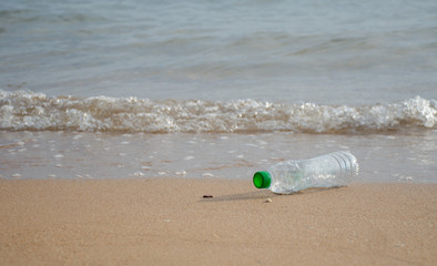 Obraz premium Water bottles were thrown on the beach. Pollution from plastic water bottles in the ocean (Environmental concept)