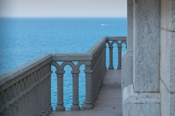 Detail of Swallow's Nest castle with seascape in summer, Crimea, Russia. Balcony of the castle on a blue sea background