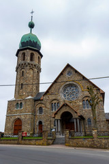 Church of the Immaculate Conception in Medell, Belgium exterior facade street view under overcast April sky