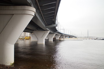 large transport overpass by the river on a cloudy day