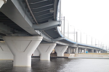 large transport overpass by the river on a cloudy day