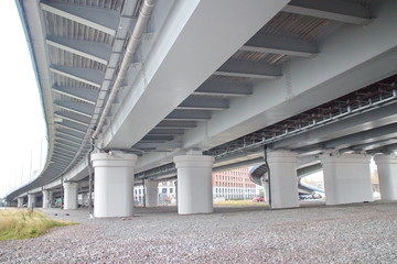 large transport overpass by the river on a cloudy day