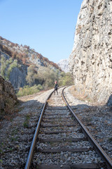 Fototapeta premium Young woman on the rail 