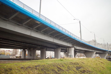 large transport overpass by the river on a cloudy day