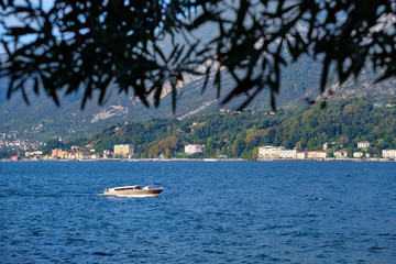 Obraz premium Panoramic view of Lake Como. Lombardy, Italy. Boat in motion on the water. Autumn season.