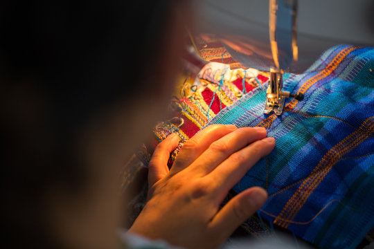 Guatemalan woman working with textiles in in San Juan La Laguna, Lake Atitlan, Guatemala