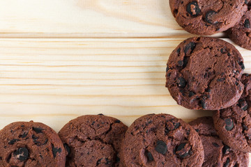 Tasty cookies with chocolate chips placed on a wooden background . Selective focus shot.