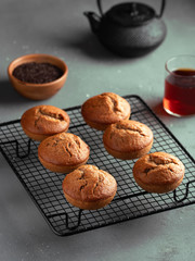 Homemade fresh banana and chocolate muffins on cooling rack.