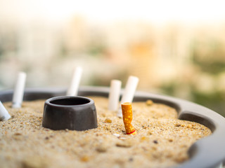 The rest of cigarettes in the ashtray. A cigarette is not good for health and environment. It is not allow to smoking in the public area in Thailand. Cigarette smoke is air pollution.