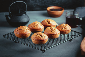 Homemade fresh banana and chocolate muffins on cooling rack.