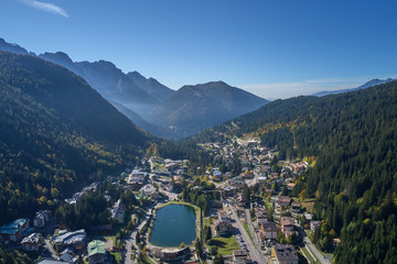 Aerial view of ski resort Madonna di Campiglio, italy. Morning is the autumn season. In the background a clear blue sky