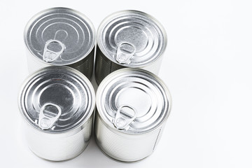 Group of silver canned food on white background.