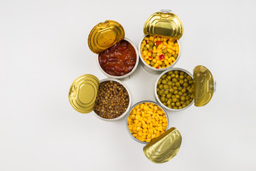 Canned food on white background. Green pea, beans, corn, lentils.