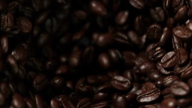 Super slow motion of rotating coffee beans in mill, speed ramping cut. Filmed on high speed cinema camera, 1000 fps.